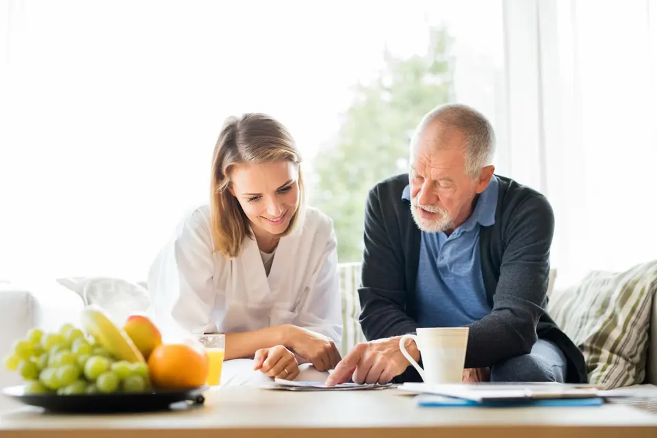 Two people reviewing wellness information together at a table.