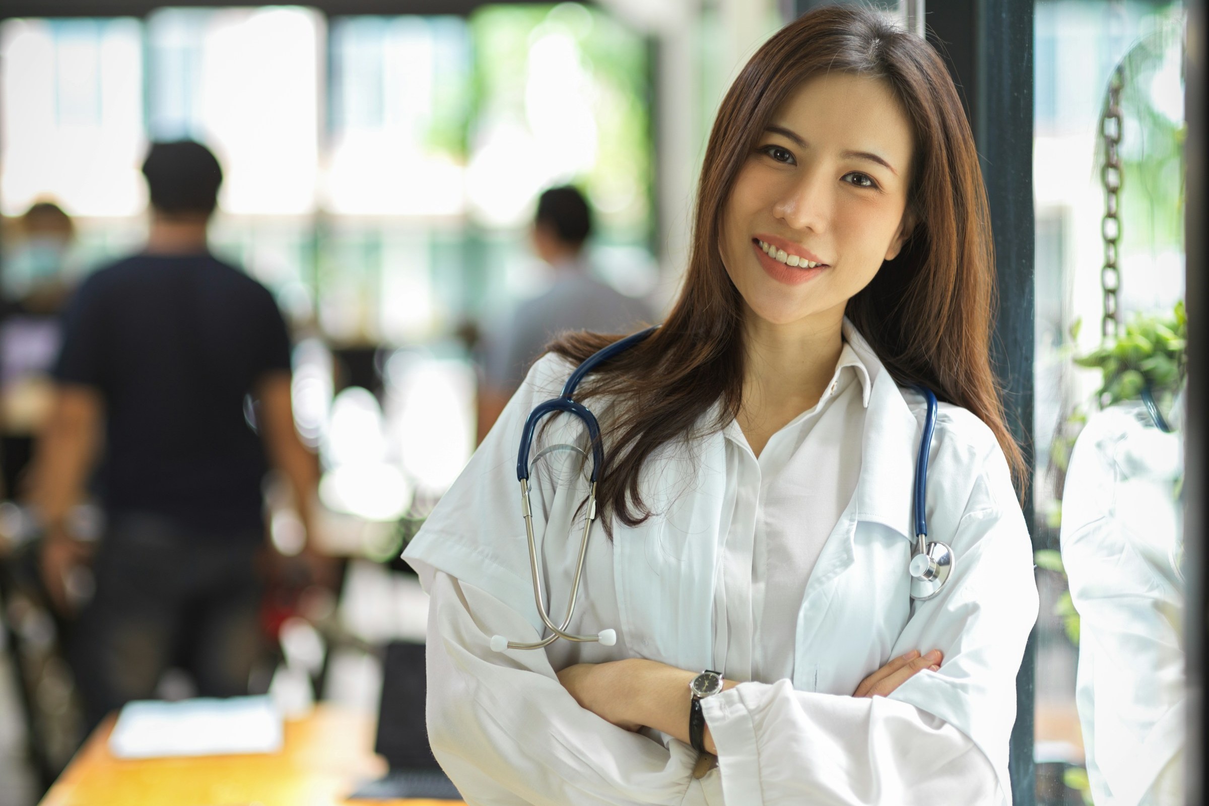 Healthcare provider wearing a stethoscope in a clinic.